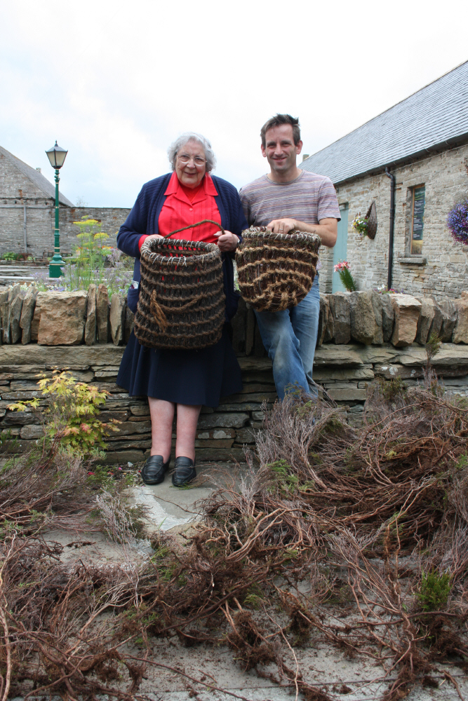 Sheila Moir with Tim Johnson and a pile of heather at the workshop