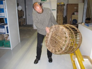 Ian Tait, Director of Shetland Museum, in the museum store, with a large wool basket