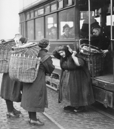 Putting creels on the tram. 1940s.